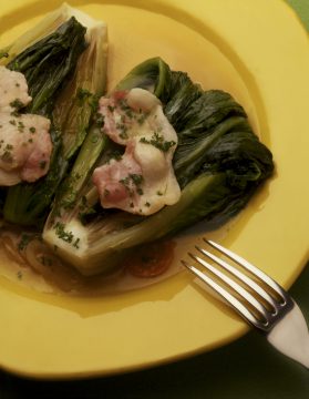 2 steamed cabbage with pieces of bacon and a parsley and tomato dressing